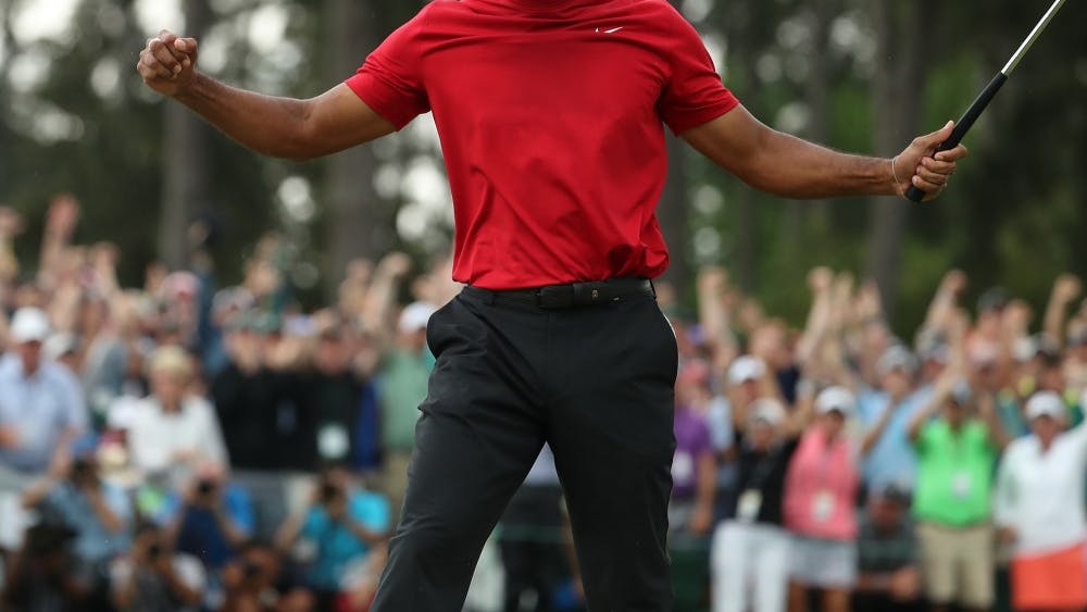 Tiger Woods celebrates after winning the Masters during the final round April 14 at Augusta National Golf Club in Augusta, Georgia.