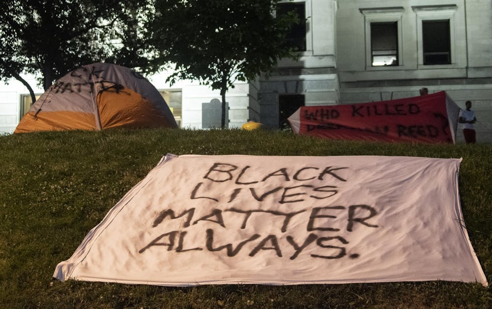 <p>Signs and tents are decorated with Black Lives Matter slogans June 9 in the grass around the Monroe County Courthouse. Some people packed up their tents while others left them standing.</p>