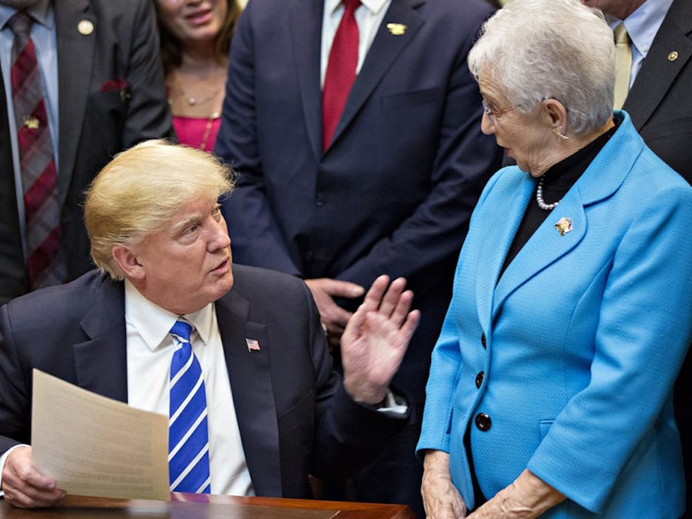 U.S. President Donald Trump speaks next to Representative Virginia Foxx, a Republican from North Carolina, right, during a bill signing ceremony in the Roosevelt Room of the White House on March 27, 2017 in Washington, D.C. (Andrew Harrer/Pool/Sipa USA/TNS) 