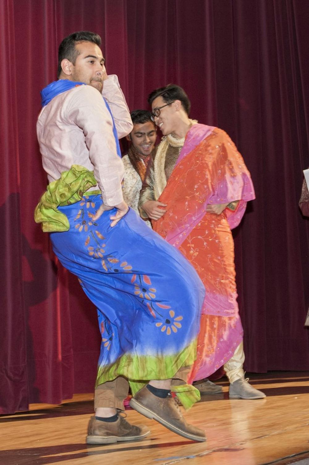 Junior Daniyal Munir, draped in a sari, models the traditional garment to cheers and applause from the audience in the Indiana Memorial Union on Friday.