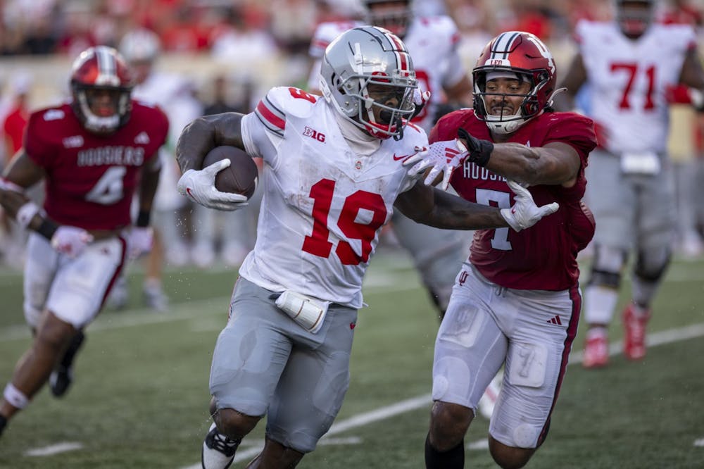 <p>Indiana sixth-year senior Jacob Mangum-Farrar attempts to tackle Ohio State senior running back Chip Trayanum Sept. 2, 2023 at Memorial Stadium in Blooomington, Indiana. The Buckeyes defeated the Hoosiers 23-3 Saturday.</p>