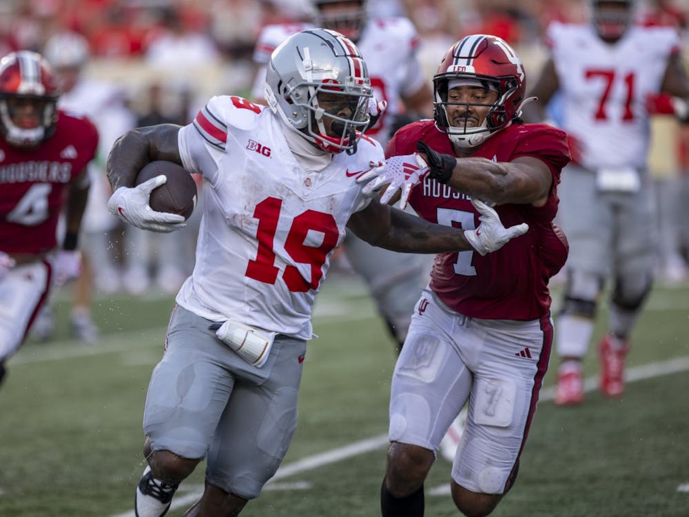 Indiana sixth-year senior Jacob Mangum-Farrar attempts to tackle Ohio State senior running back Chip Trayanum Sept. 2, 2023 at Memorial Stadium in Blooomington, Indiana. The Buckeyes defeated the Hoosiers 23-3 Saturday.