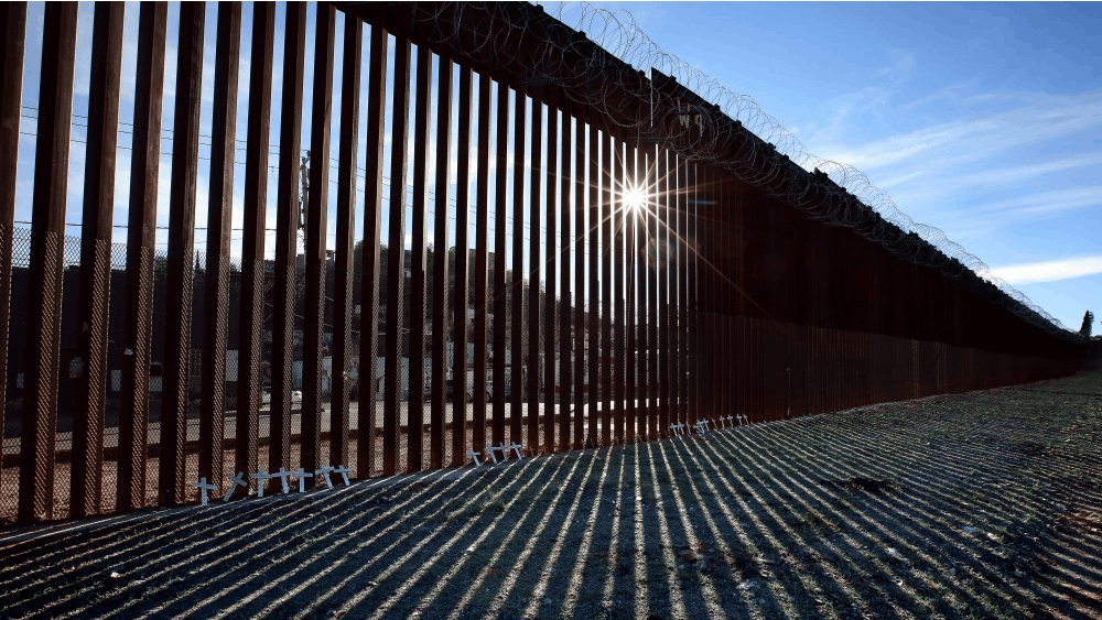 The border wall is seen from the Nogales, Arizona side looking west into Mexico. The Trump administration asked the U.S. Supreme Court to allow nationwide enforcement of a new rule that would limit who can apply for asylum at the Mexican border.