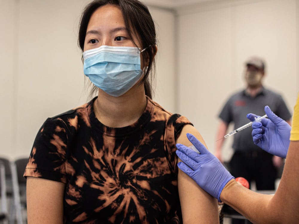 IU sophomore Alanna Wu receives her COVID-19 vaccination at the Orange County Community Center in Paoli, Indiana. Multiple vaccines satisfy the university&#x27;s requirement, according to IU.