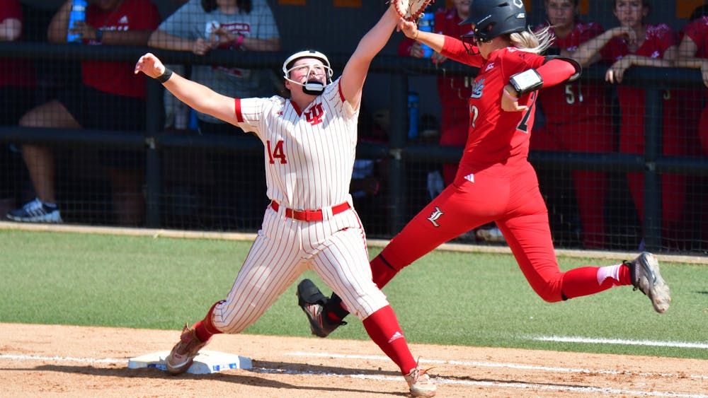 Indiana sophomore utility player Sarah Stone catches the ball at first base against the University of Louisville Friday, May 19. Indiana won 4-3 to move to the winners' bracket of the NCAA Tournament's Knoxville regional. 