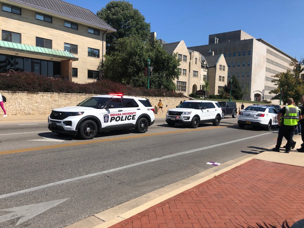 <p>Three Indiana University Police Department vehicles gather on 10th Street on Sept. 14, 2023. A vehicle struck an IU student traveling on a scooter at the intersection of Woodlawn Avenue and 10th Street today, according to IU Public Safety Communications Manager Mary Keck.<br/><br/><br/><br/>﻿</p>
