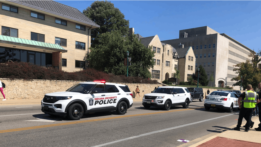 Three Indiana University Police Department vehicles gather on 10th Street on Sept. 14, 2023. A vehicle struck an IU student traveling on a scooter at the intersection of Woodlawn Avenue and 10th Street today, according to IU Public Safety Communications Manager Mary Keck.﻿