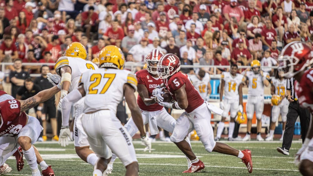 Quarterback Michael Penix Jr. hands the ball to running back Stephen Carr during the game against the University of Idaho on Sept. 11, 2021 at Memorial Stadium. Indiana beat the University of Western Kentucky Hilltoppers by a score of 33-31. 