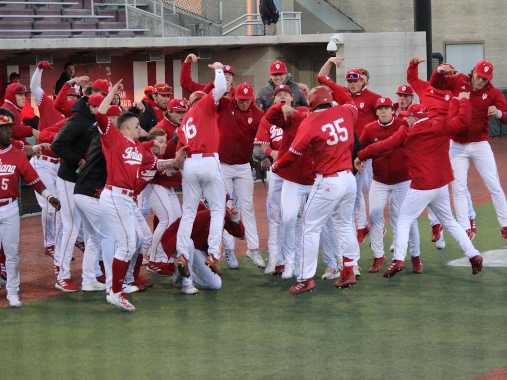 Junior Matthew Ellis celebrates with his Indiana teammates after hitting a two-run home run in the seventh inning to extend the Hoosiers’ lead to 9-1 against Purdue University Fort Wayne on Wednesday. IU won 12-2. CORRECTION: A previous version of this caption misstated the name of Purdue University Fort Wayne. 