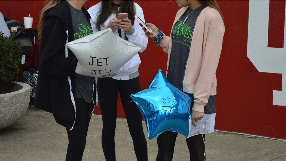 Right before the Out of the Darkness Walk began, participants wrote the names of ones who they had lost to suicide on balloons for a balloon release Sunday afternoon. 