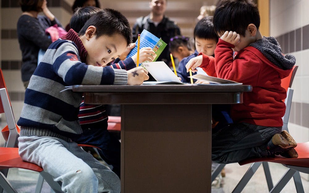 An elementary-age boy fills in a crossword puzzle about Martin Luther King Jr. during the MLK Birthday Celebration. The community teach-in, for both children and their families, took place&nbsp;Sunday in&nbsp;the IU School of Education. The celebration included coloring activities, a musical performance, an interactive discussion and a celebratory birthday cake.