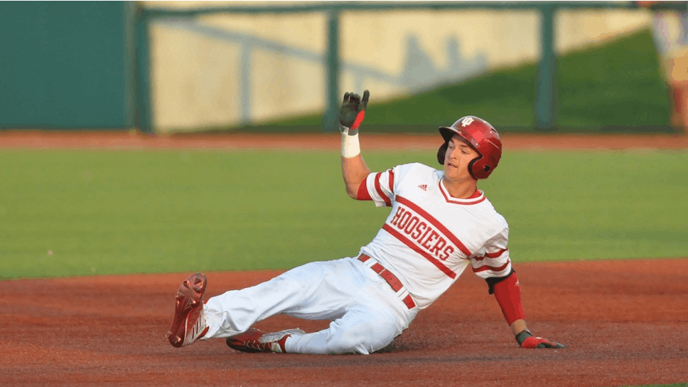 Matt Gorski slides in to second base after his double scores Indiana’s fourth run of the game on Wednesday at Bart Kaufman Field. Indiana ultimately lost to Butler 7-5.