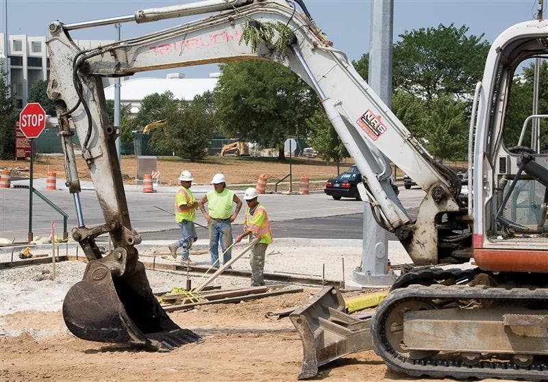 Construction crews continue work at the intersection of 17th Street and North Fee Lane Tuesday afternoon. As campus move in ramps up, construction workers are looking for ways to accommodate the sharp increase in campus automobile traffic.