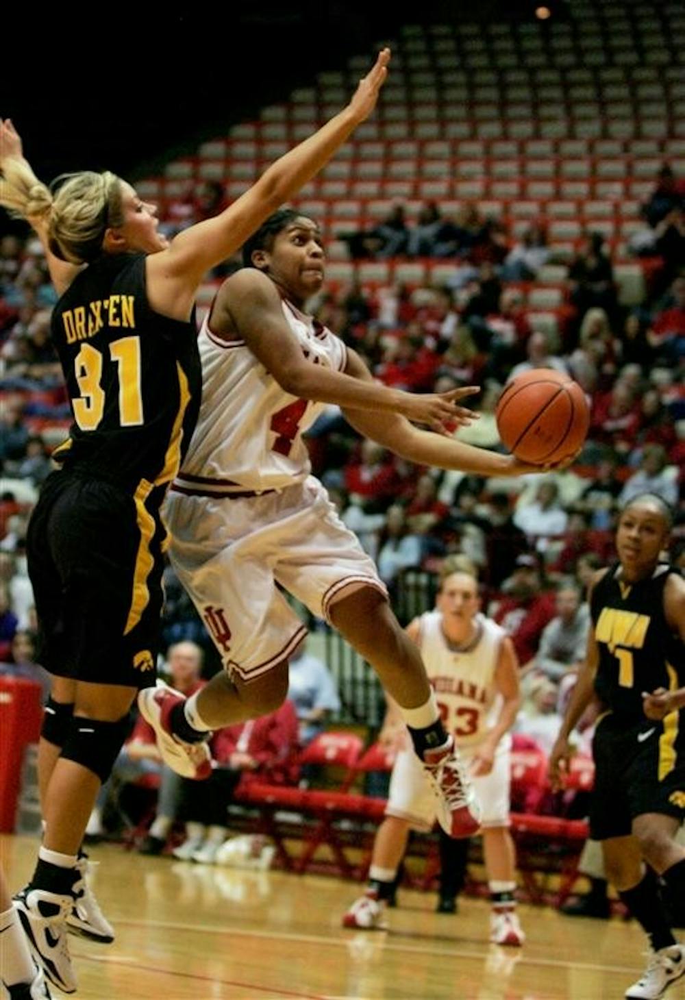 Freshman guard Ashlee Mells goes for a reverse layup as Iowa's Hannah Draxten attempts to block her Sunday at Assembly Hall. The Hoosiers face Penn State on the road this Sunday.