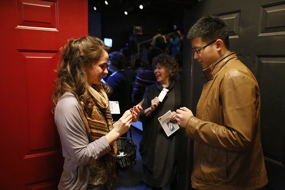 Volunteer Carrey Jaroski takes tickets at the door of the Timothy J Wiles Theater thursday for Bloomington Playwrights Project's show "The Blizzard: 30 Drinksin 60 Minutes!" 