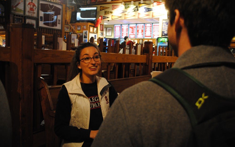 IU Republicans Chairwoman Reagan Kurk speaks with attendees at the "Right Wing Night" event at Buffa Louie's Monday. The outreach event brought enough students to completely fill the lower level of the restaurant and almost the middle.