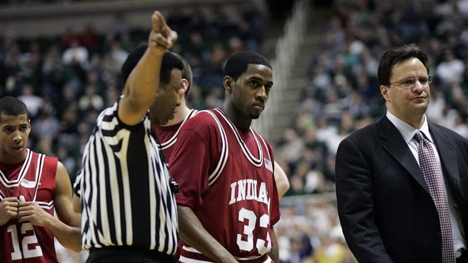 Referee Ed Hightower signals that junior guard Devan Dumes (33) has been ejected during IU's 75-47 loss to Michigan State in East Lansing, Mich. Dumes was ejected after throwing an elbow at Michigan State players.