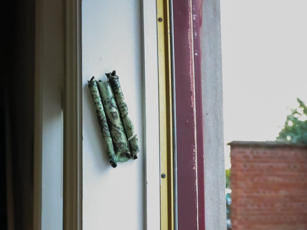 A mezuzah sits on the doorway of the Hillel House. This mezuzah sits on a side door to the house so that faculty members and students are able to perform the tradition of touching the scroll and kissing the tips of the fingers after. The scroll inside is sacred to the Jewish religion. 
