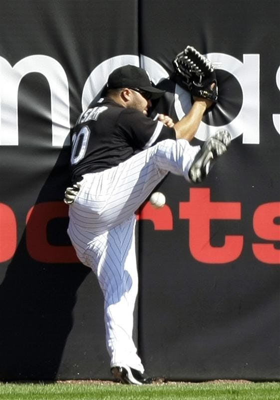 Chicago White Sox left fielder Nick Swisher crashes against the wall unable to catch a double by Toronto Blue Jays' Lyle Overbay during the fifth inning of the first game of a double-header baseball game on Tuesday in Chicago.