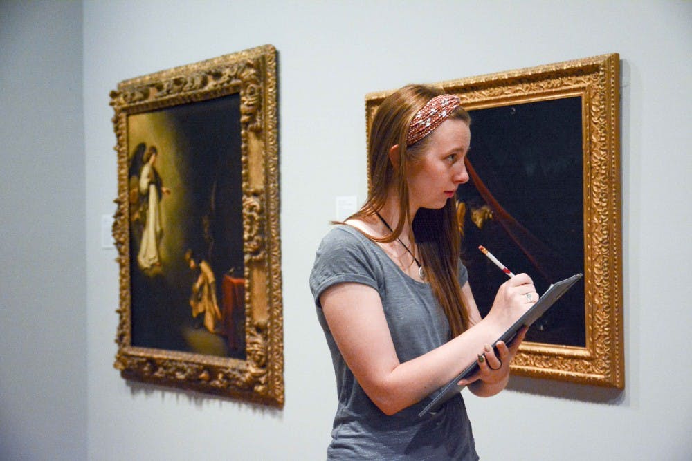 Bailey Foust, a recent art history graduate from IU, takes note during the observation Friday afternoon at the Eskenazi Museum of Art. Observing detailed visual elements is the first step in art history research. 