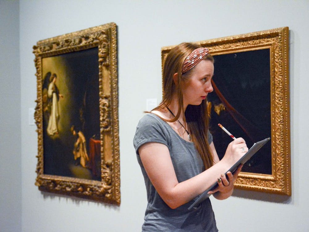Bailey Foust, a recent art history graduate from IU, takes note during the observation Friday afternoon at the Eskenazi Museum of Art. Observing detailed visual elements is the first step in art history research. 