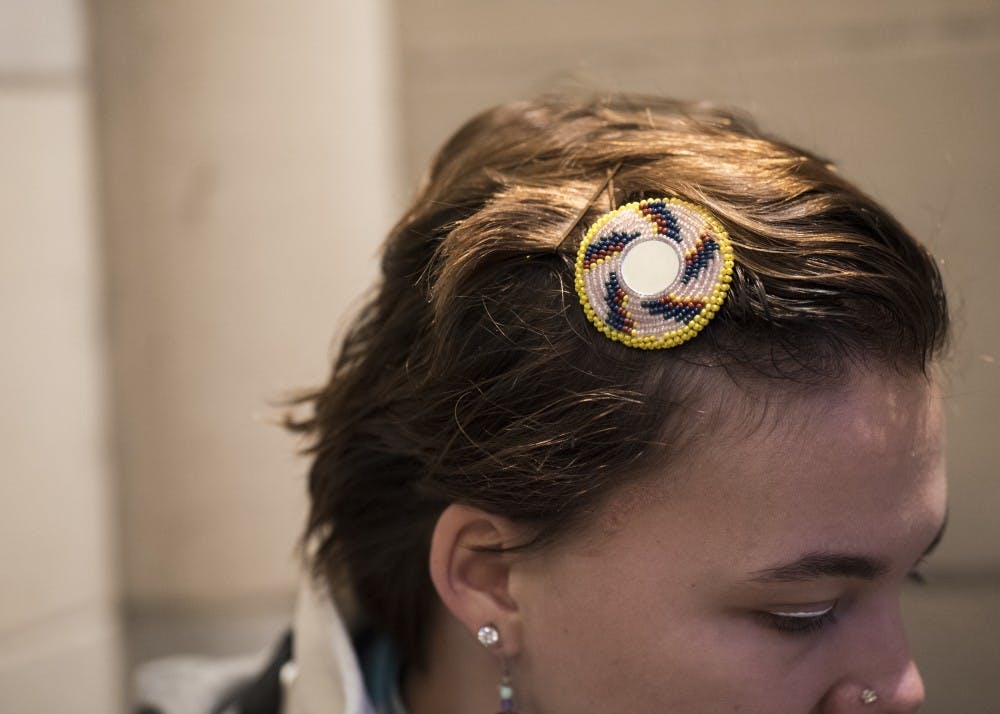 Senior Gaby Anderson, a senior studying apparel merchandising, made this multicolored barrette herself. Anderson is of Kiowa decent but is not a registered member of the tribe.&nbsp;