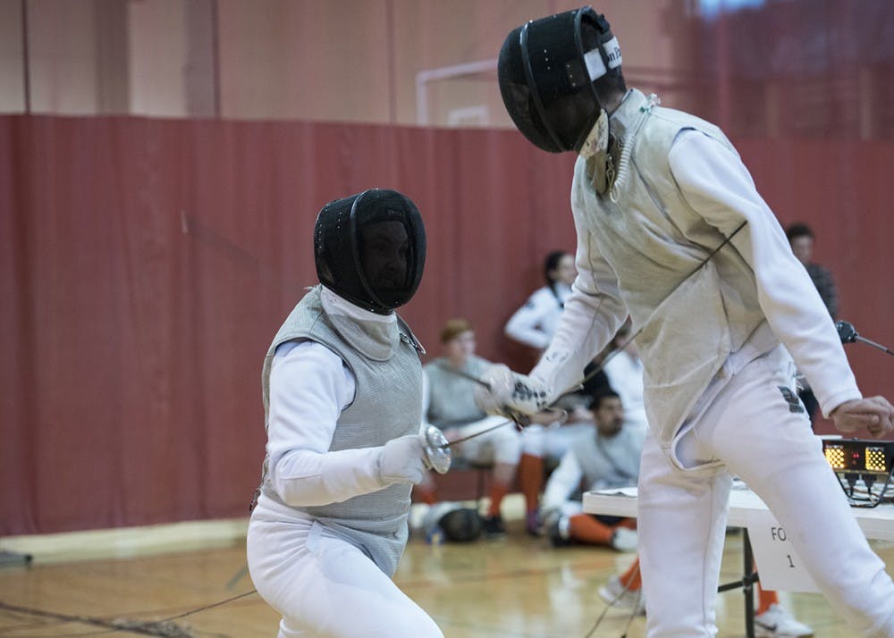 Junior Micheal Zelenka competes second in the foil match against Illinois. Men's foil fencing lost 4-5 to Illinois.
