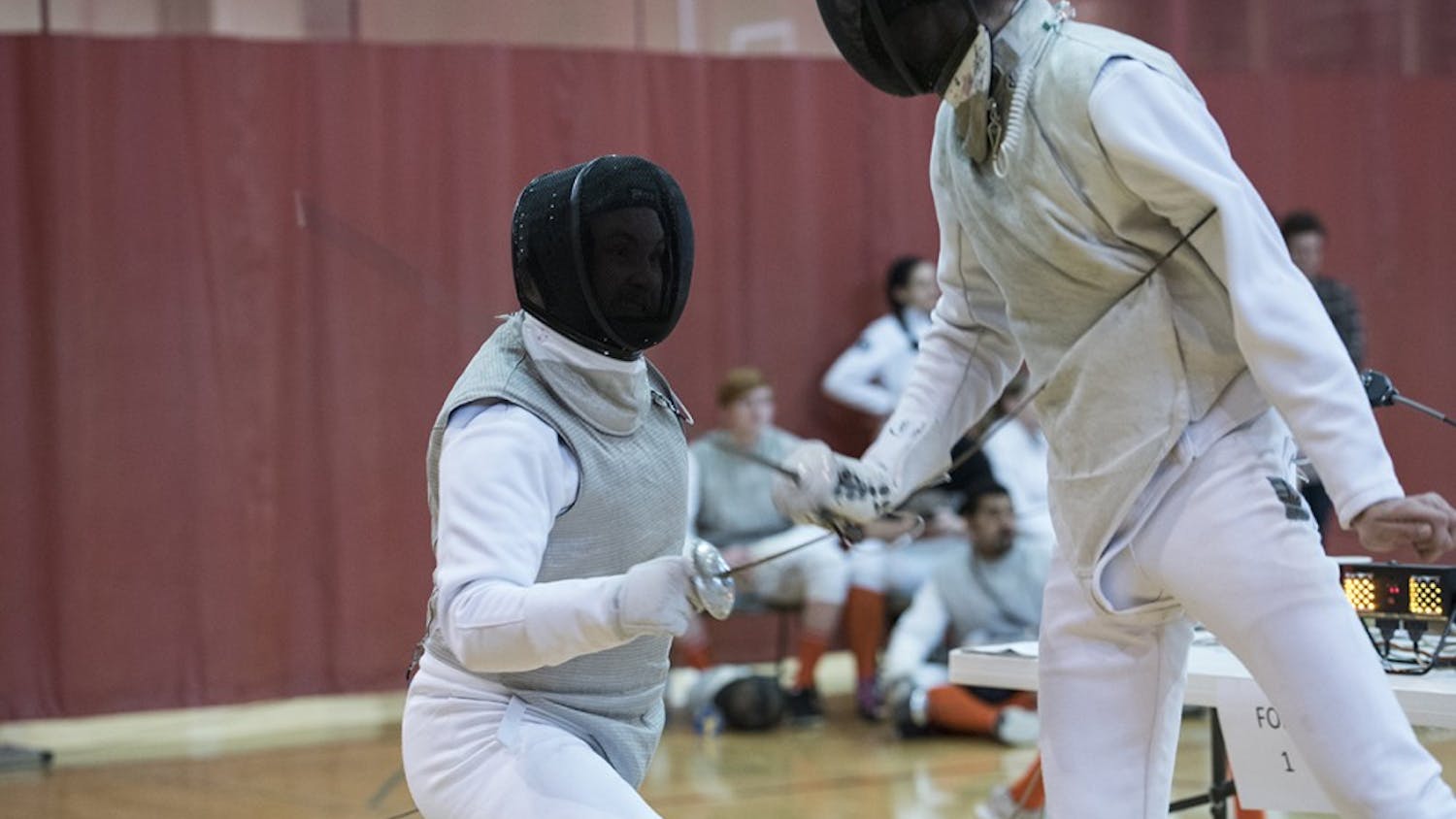 Junior Micheal Zelenka competes second in the foil match against Illinois. Men's foil fencing lost 4-5 to Illinois.