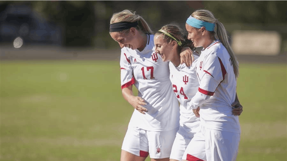 Members of the Indiana women's soccer team celebrate following Sunday's 1-0 victory against Wisconsin on Senior Day at Bill Armstrong Stadium.