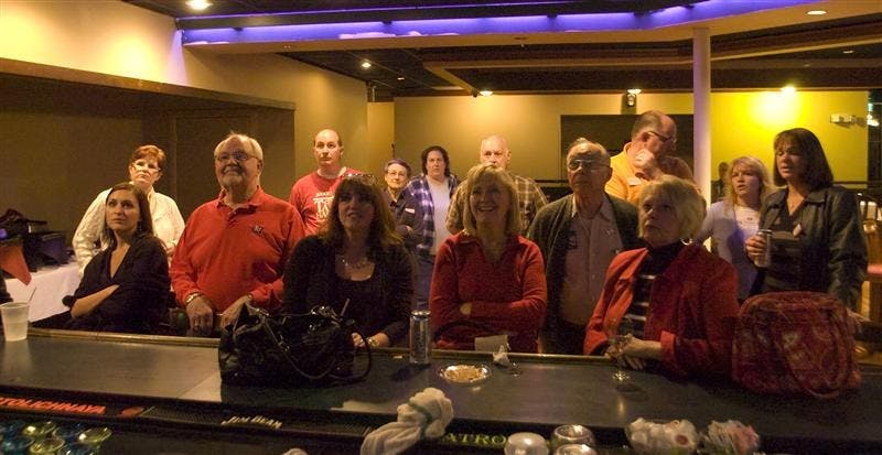 People gathered at Republican campaign headquarters in Monroe County watch television monitors as Governor Mitch Daniels delivered his victory speech Tuesday night. 