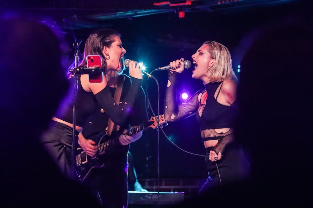 <p>Lead singers Emma Spartz and Julia Rusyniak sing Oct. 31, 2021, at the Bluebird. The first time Spartz and Rusyniak met was two weeks before Six Foot Blonde began as a band. "It's hard for me to perform without her and I think it's vice versa," Rusyniak said of Spartz. "I think a lot of the time people would assume that we were comparing ourselves to each other, competing, but the crazy thing is that it works perfectly."</p>