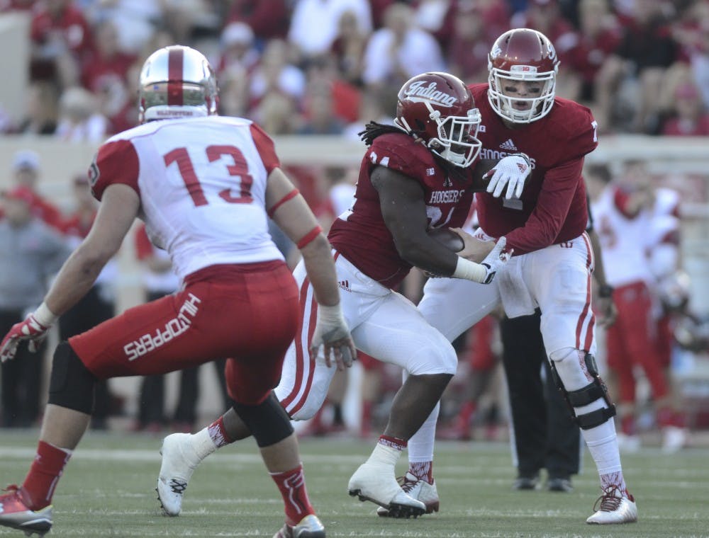 Quarterback Nate Sudfeld hands off the ball to running back Devine Redding during the game against Western Kentucky on Saturday at Memorial Stadium. The Hoosiers won, 38-35.