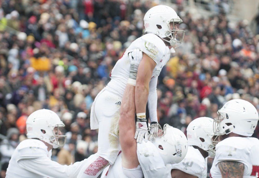 Offensive lineman Dan Feeney lifts wide receiver Mitchell Paige after Paige scored against Purdue on Saturday at Ross-Ade Stadium. The Hoosiers won 54-36.