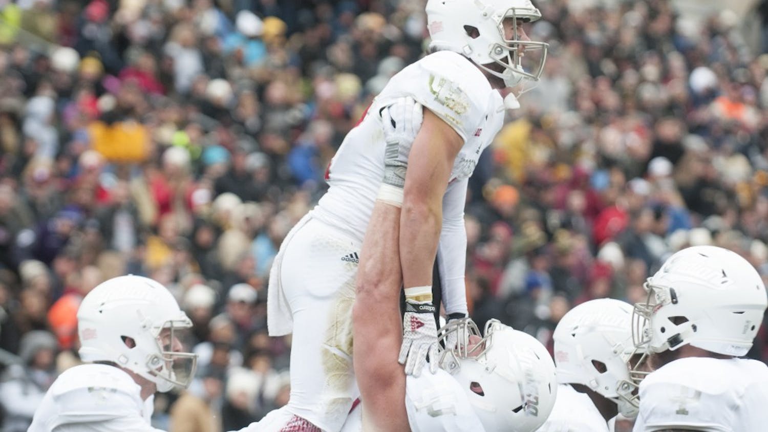 Offensive lineman Dan Feeney lifts wide receiver Mitchell Paige after Paige scored against Purdue on Saturday at Ross-Ade Stadium. The Hoosiers won 54-36.