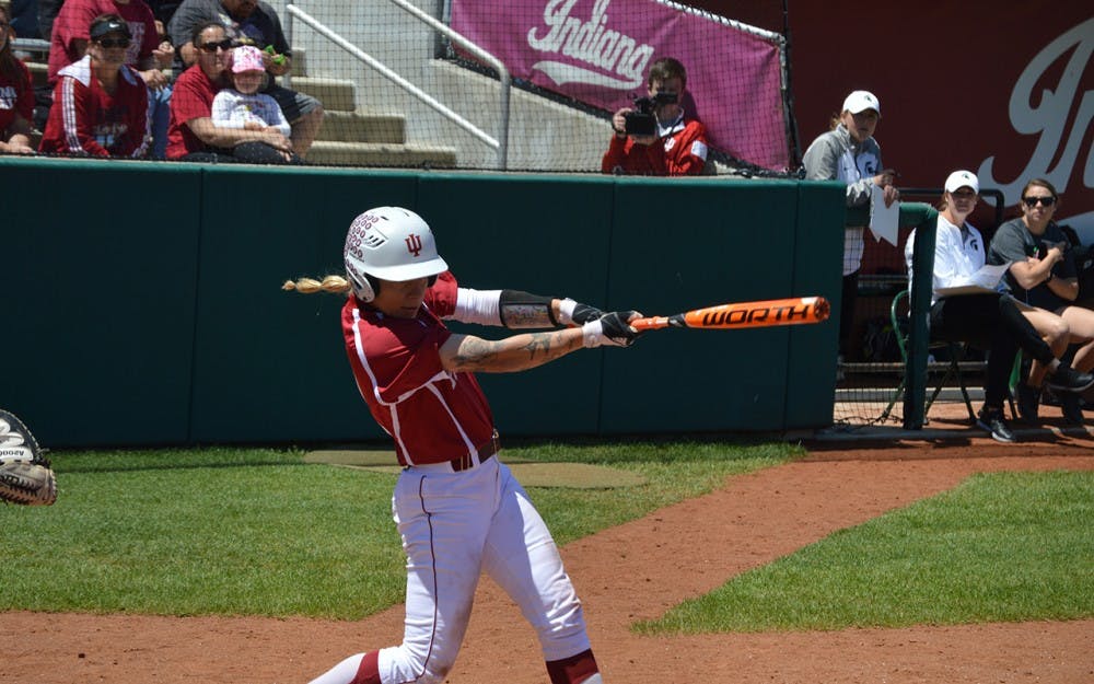 Junior Rachel O'Malley swings and makes contact with the ball during the IU's game against Michigan State Sunday afternoon. The Hoosiers lost to the Spartans 6-5.