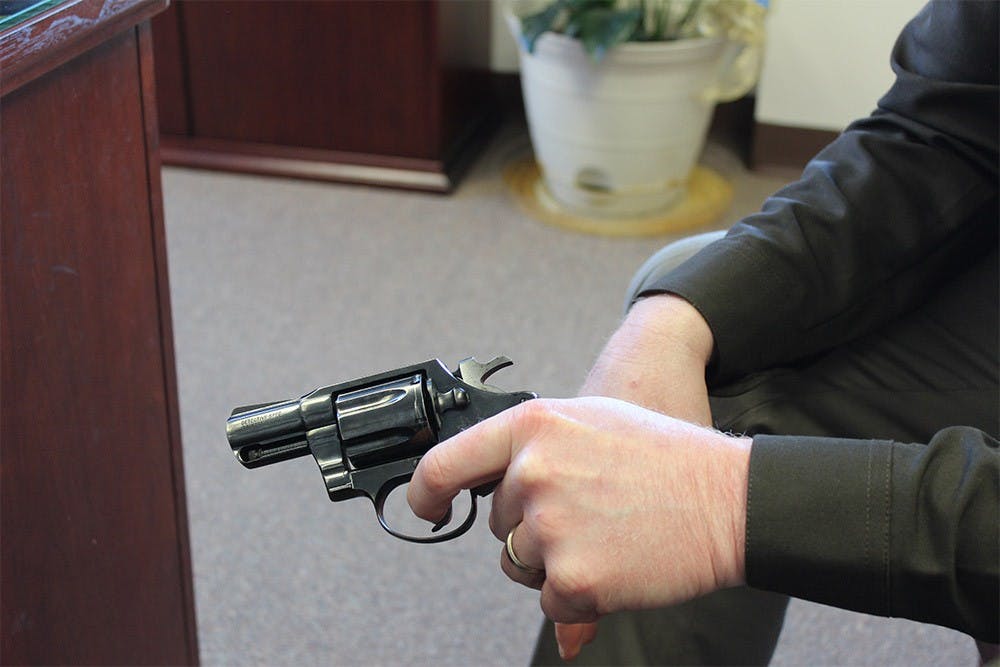 Sheriff Matt Myers holds a .38 caliber pistol, the same type of weapon used by a 6-year-boy who accidently shot his father Sunday in Barthlomew county.