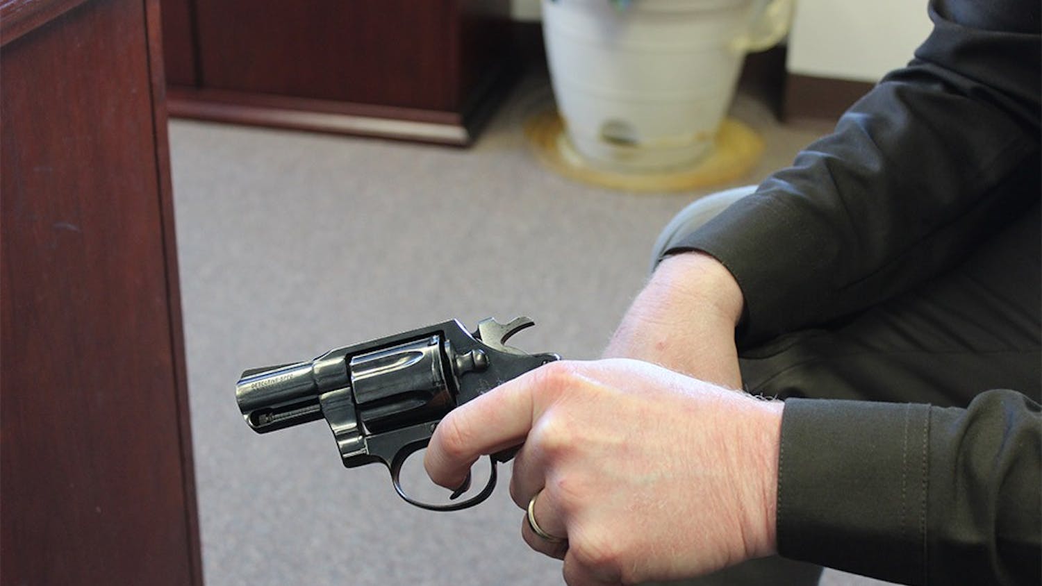 Sheriff Matt Myers holds a .38 caliber pistol, the same type of weapon used by a 6-year-boy who accidently shot his father Sunday in Barthlomew county.