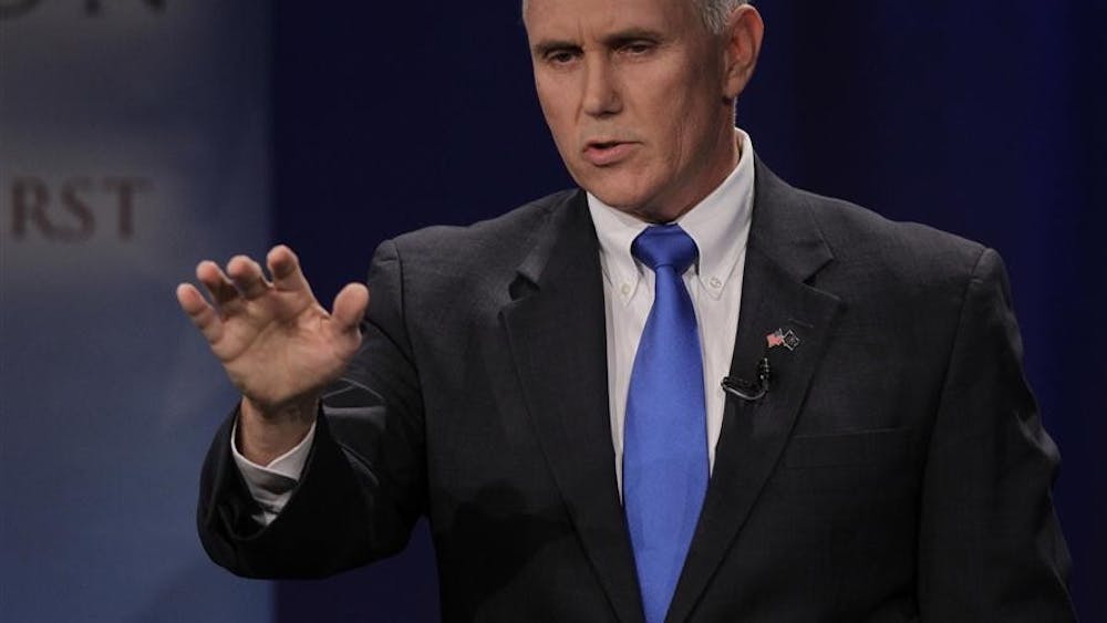 Indiana gubernatorial candidate Republican Mike Pence makes a point as he participates in a debate with Libertarian Rupert Boneham and Democrat John Gregg in Fort Wayne, Ind. on Thursday.
