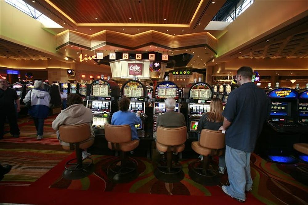 Guests try out some of the games just after the doors opened for the grand opening of the permanent Indiana Live Casino on Friday in Shelbyville, Ind. The track's Indiana Live casino opened in a temporary building last June. Interstate 74 was backed up for about three miles as traffic jammed the casino exit.