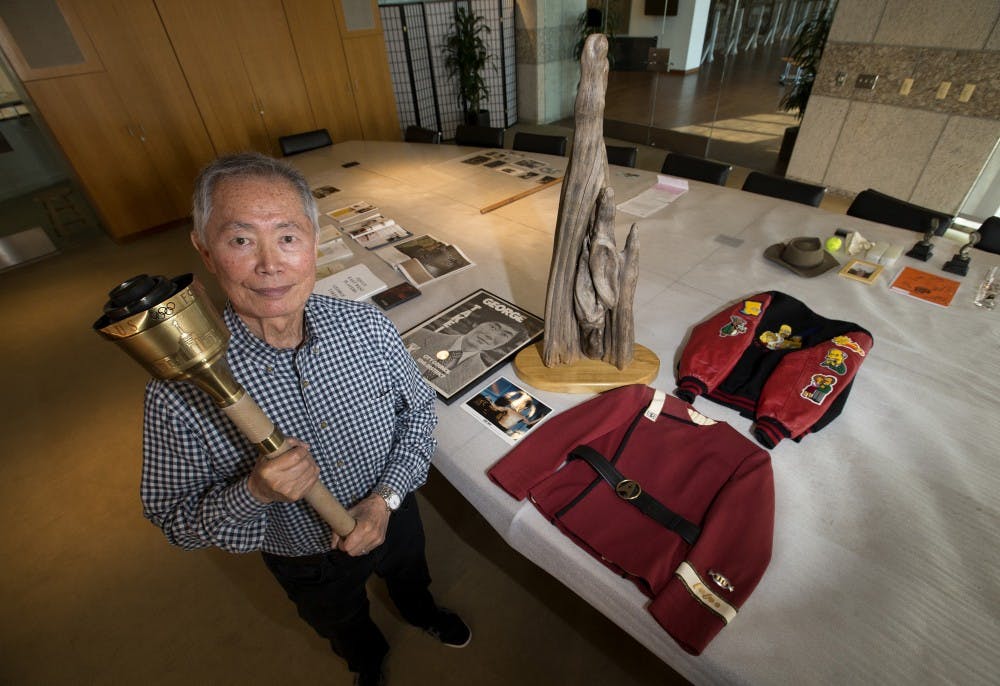 <p>George Takei, "Star Trek's" original Mr. Sulu, shown holding the Olympic torch he carried in the 1984 Olympics, will give a talk titled “Diversity, Difference, Otherness: An Evening with George Takei" on Sept. 9. (Allen J. Schaben/Los Angeles Times/TNS)</p>