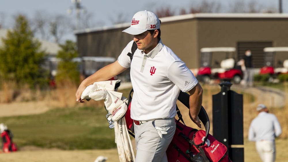 Senior Tate Heintzelman puts on his bag during the Hoosier Collegiate Invitational on April 4 at the Pfau Course. The IU men&#x27;s golf team will be competing at the Robert Kepler Intercollegiate on Saturday and Sunday in Columbus, Ohio.