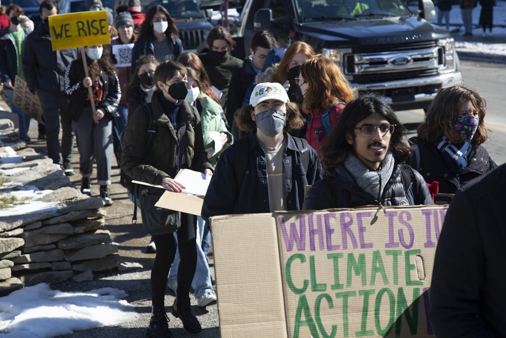 <p>Demonstrators on Feb. 8, 2022, march down Tenth Street. Sunrise Bloomington called on the IU Foundation to fully disclose their investments, divest from fossil fuels and reinvest in green energy.</p>
