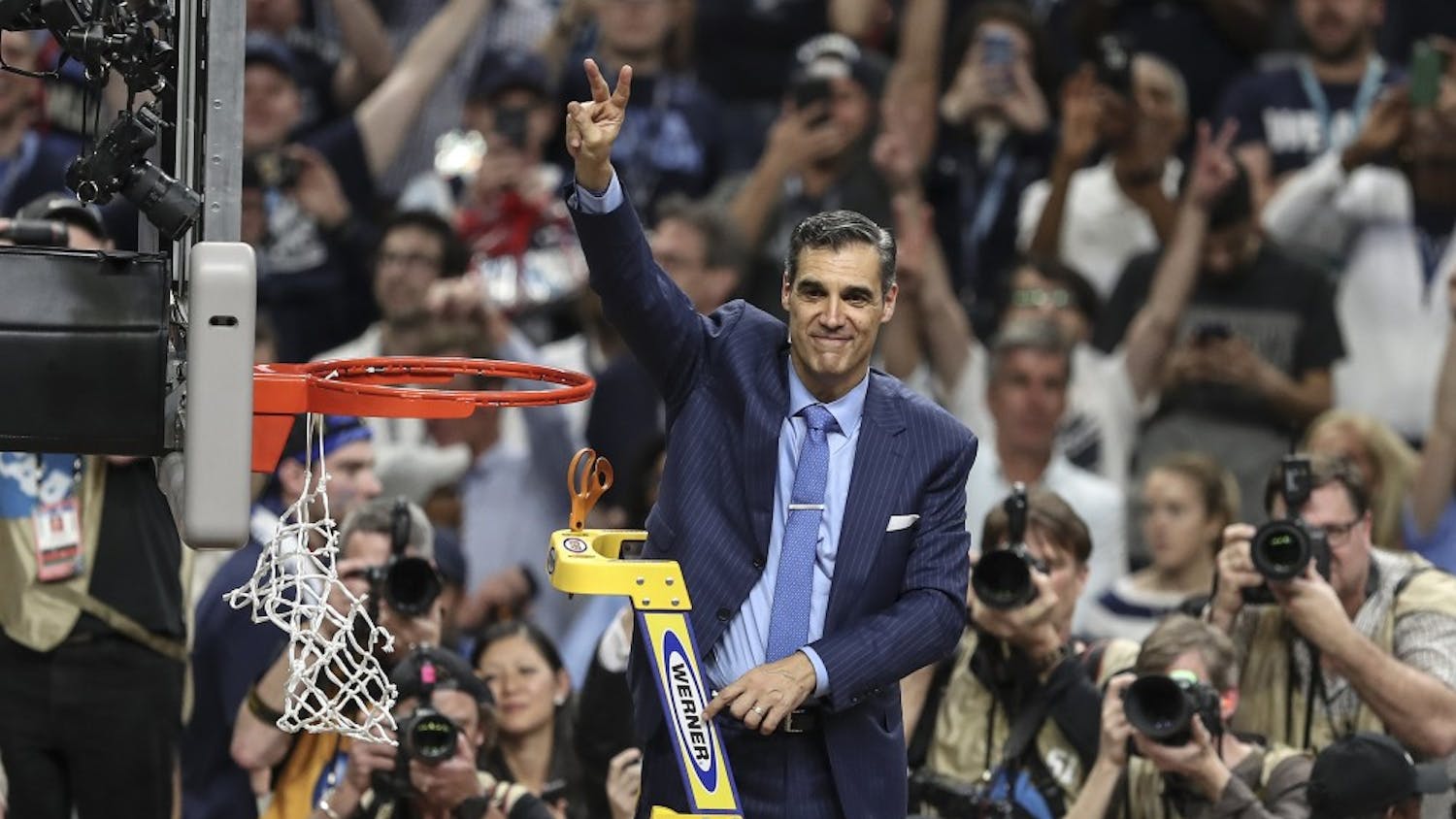 Villanova head coach Jay Wright waves the Villanova "V" to the fans while cutting the net after beating Michigan to win the NCAA National Championship on Monday, April 2, 2018, at the Alamodome in San Antonio, Texas. The Villanova team is the National Champion, beating Michigan 79-62.&nbsp;