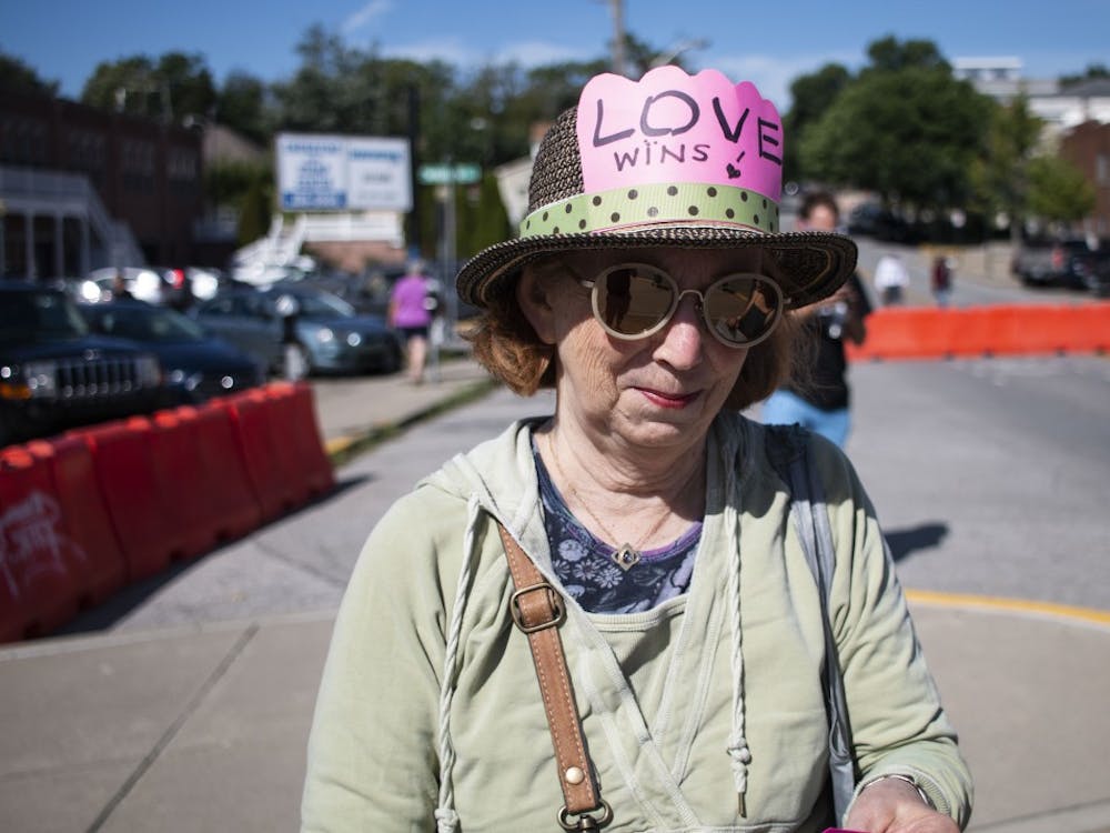 A Bloomington resident and marketgoer wears a hat with the words “Love wins” on it to the Bloomington Community Farmers’ Market on Aug. 24. The woman has been outspoken in the past about the presence of vendor Schooner Creek Farm, which is run by white supremacists.&nbsp;