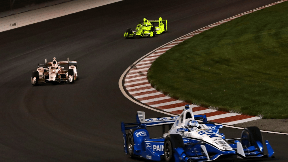Josef Newgarden, right, of Team Penske is followed by team members Helio Castroneves, left, and Simon Pagenaud in the Bommarito Automotive Group 500 IndyCar race on Saturday, Aug. 26, 2017, at Gateway Motorsports. Castroneves won the 2021 Indy 500.