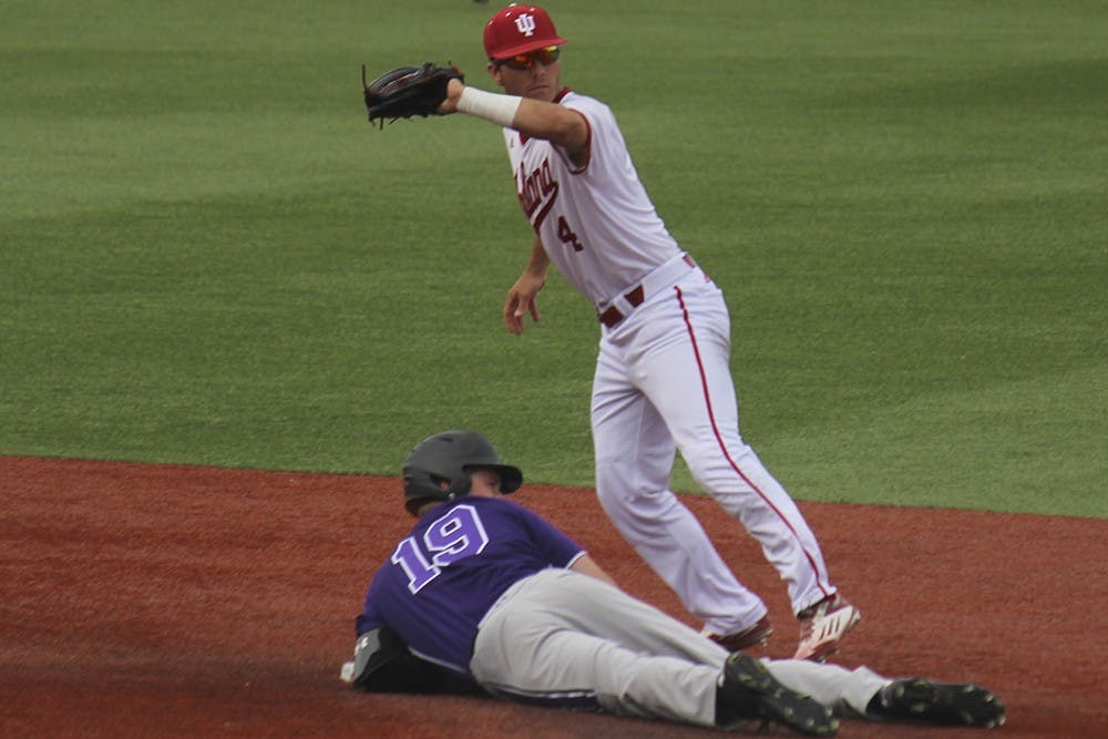 Junior second baseman Tony Butler tags out a Northwestern runner during the first game on Friday at Bart Kaufman stadium. The Hoosiers won the first game 2-1.