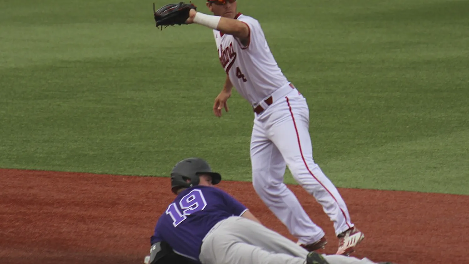 Junior second baseman Tony Butler tags out a Northwestern runner during the first game on Friday at Bart Kaufman stadium. The Hoosiers won the first game 2-1.