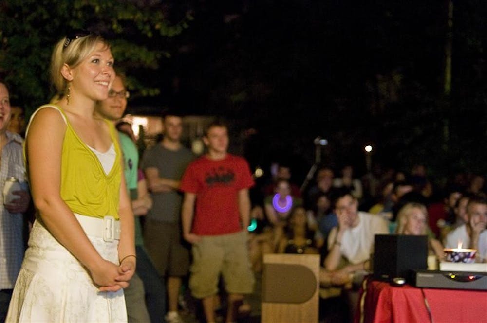 Rose Byrne, co-president of Campaign for Change, smiles at a joke in Barack Obama's speech during a viewing party Thursday night in the backyard of a home on East 11th Street.