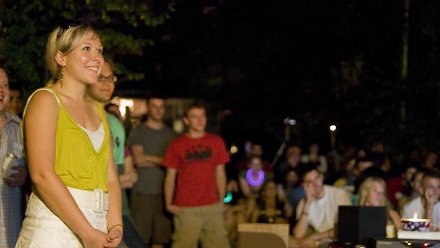 Rose Byrne, co-president of Campaign for Change, smiles at a joke in Barack Obama's speech during a viewing party Thursday night in the backyard of a home on East 11th Street.