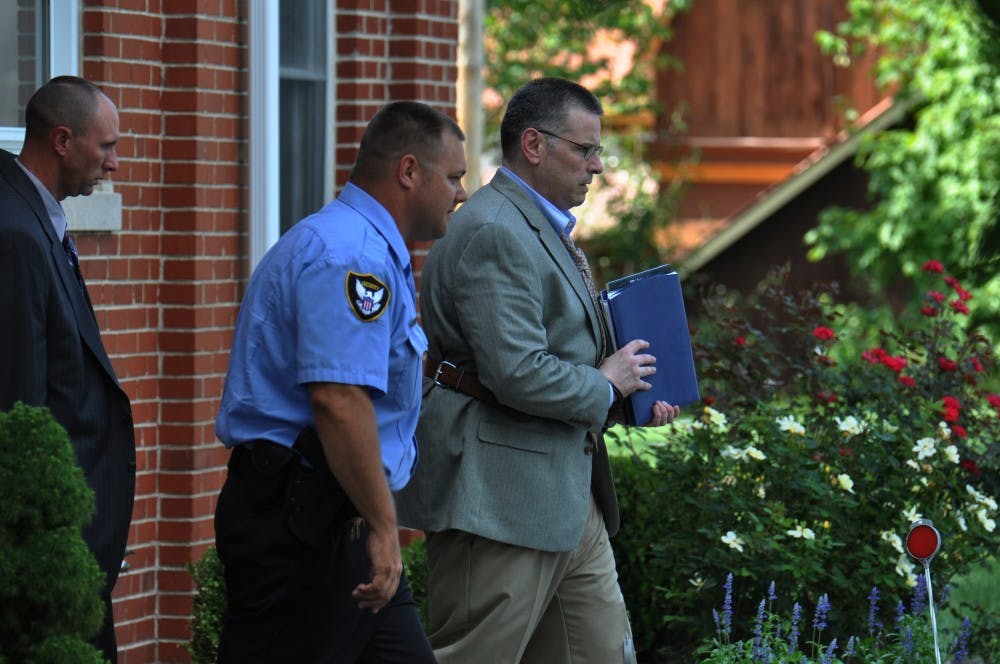 Daniel Messel is led out of the Brown County Courthouse and to a waiting car in Nashville, IN on Friday.